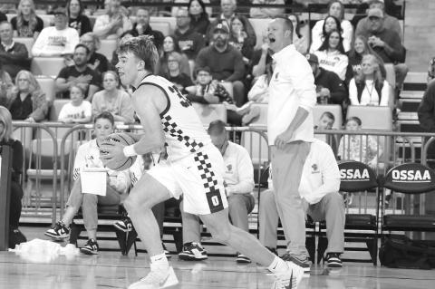 OKARCHE COACH Aaron West (background) barks instruction to his team and Easton Roby prepares to pass it up the floor during Wednesday’s quarterfinal win at OG&amp;E Coliseum. [KT&amp;FP Staff Photo]