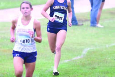 KINGFISHER’S SCOUT Snodgrass ran down Southwest Covenant’s Allie Sheppard (9070) in the final 100 meters on Saturday to place second. [KT&amp;FP Staff Photo]