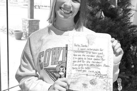 MIA HARTMAN shows off the letter she wrote to Santa Claus as a pre-k student. Her pre-k teacher, Laurie Hagar, saved the letters and recently presented them to Hartman and other KHS seniors who were in her class. [Photo provided]