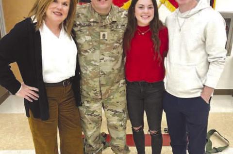 COMMAND SGT. MAJOR Dave Slezickey is pictured above in his official U.S. Department of the Army photo. Slezickey has a military career spanning more than 30 years. On the left is the former Kingfisher city manager along with his wife, Melissa, and their c