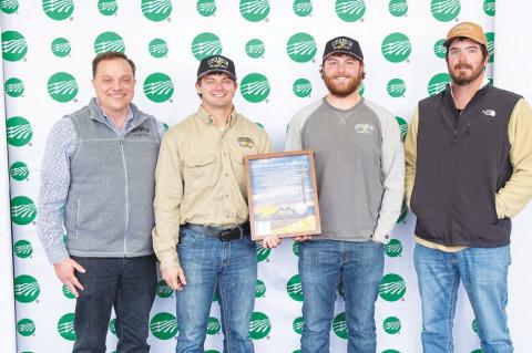 CIMARRON ELECTRIC CEO Aaron Roark, far left, with journeyman linemen, from left, Reid Trout, Jack Taylor and Zac Smith. The linemen recently took part in a project that help bring first-time electricity to an area of New Mexico. [Photo provided]