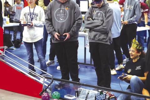 REGIONAL COMPETITION – Kingfisher’s Bob-Bots members (above) Will Finley and Raiden Clarke work together during one of the matches at the FTC regional held Saturday at the APB. The Bob-Bots qualified for state as did Okarche’s WarriorBots. Pictured 