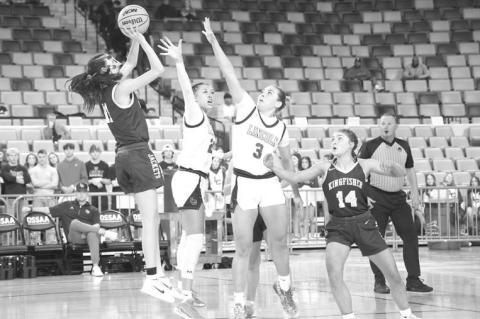 KHS SOPHOMORE Ela Hartman shoots over a pair of Lincoln Christian defenders during the first half of Tuesday’s contest in Oklahoma City. [KT&amp;FP Staff Photo]