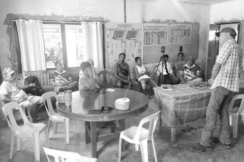 BISON CO-OP President Todd Vaverka of Hennessey, far right, talks with a group of rice farmers in the Philippines during his current trip. The farmers are interested in forming a cooperative to help them better control prices at harvest time. [Photo provi