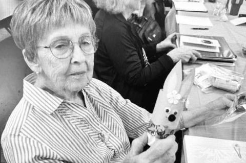 HENNESSEY FARMERETTE member Kathy Patocka holding one of the Easter craft projects the group made for the library during its March meeting. [Photo provided]