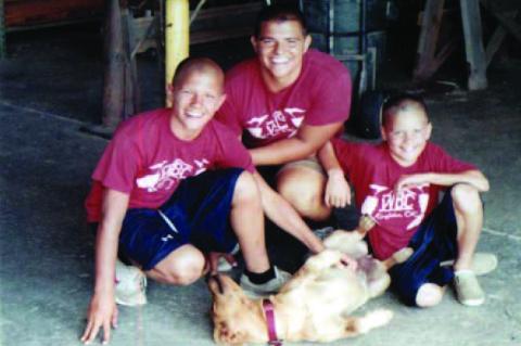 THE WALTER BOYS, working at the store 16 years ago. From left; Will, Robert and Sam with Gracie, one of the many dogs the Walter family has had over the years.