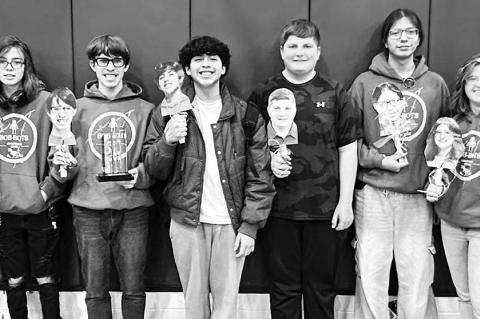 BOB-BOTS team members include, from left, coach Kurt Kaya, Audrey Heckman, Raiden Clarke, Josue Garcia, Will Finley, Dallen Russell, Savana Reherman and coach Melody Kuehn. Not pictured is Finley Harrison (although Kuehn is holding up a photo of him). [Ph