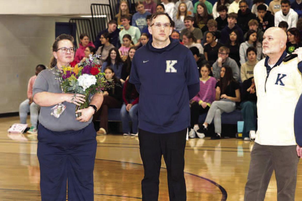 TOP TEACHER – SuperintendentAndy Evans (far right) addresses the crowd during an assembly on Tuesday at which Mandy Owens was announced as the KPS Teacher of the Year. The district’s band director, Owens (second from left) teaches students at three di