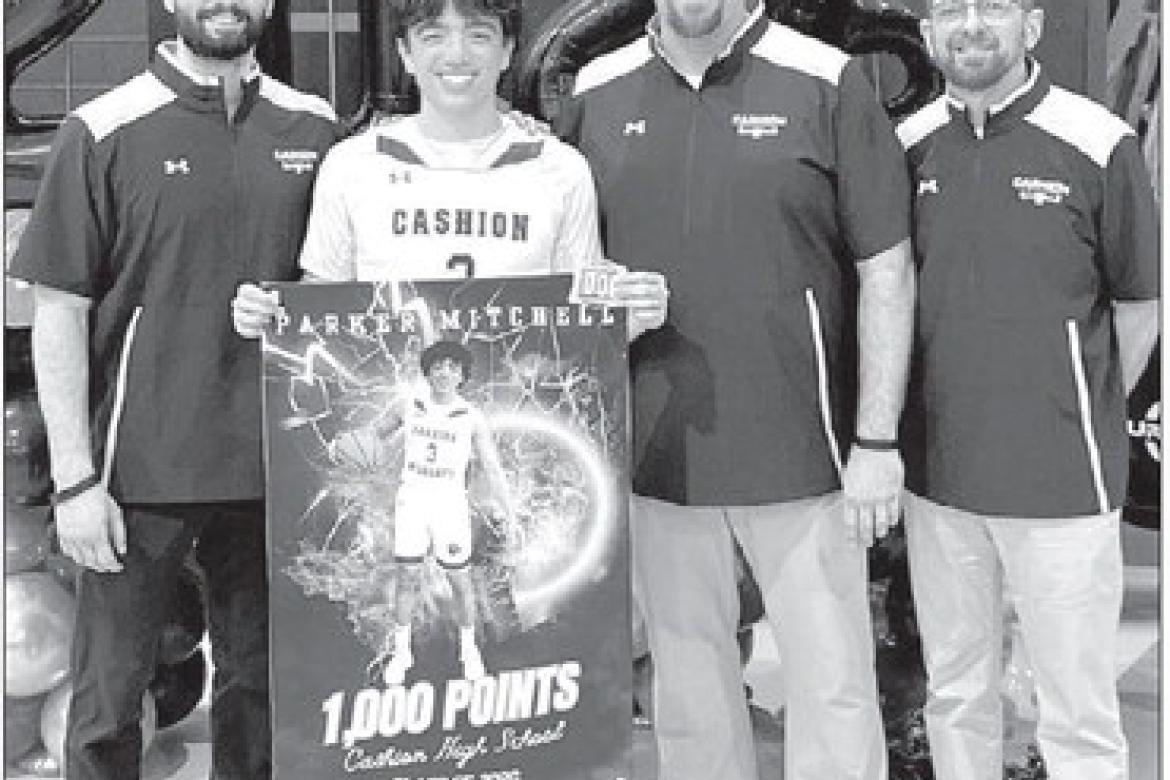 CASHION SENIOR guard Parker Mitchell was recognized prior to a game last week for surpasing 1,000 career points earlier this season. He’s pictured with Cashion coaches, from left, Brady Johnson, John Hardaway and Chad Tichenor. [Photo provided]