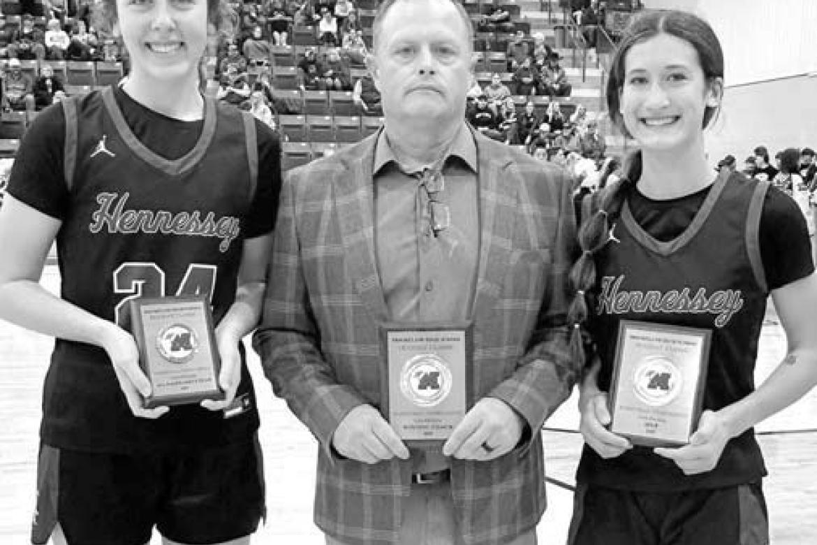 HENNESSEY’S Emma Copeland (right) was the MVP and Clare Munroe (left) joined her on the all-tournament team at Mooreland. They’re joined by their coach Brian Richardson after claiming the championship. [Photo provided]