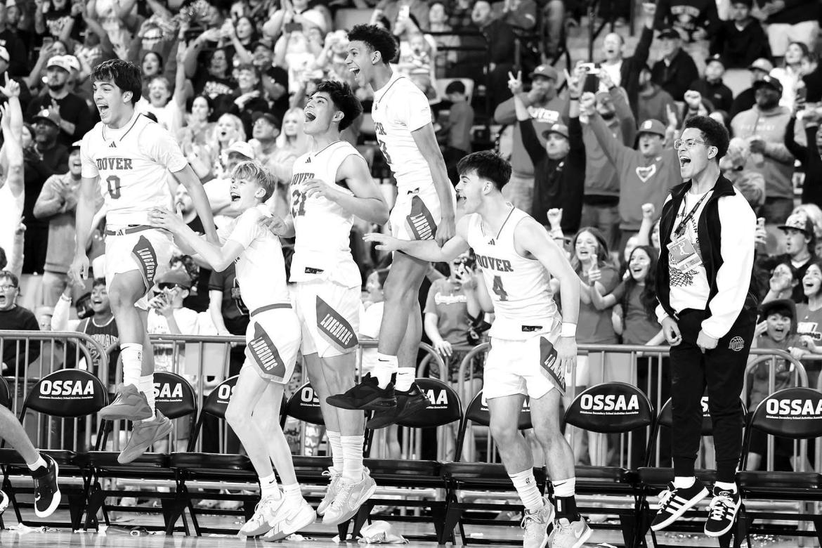 DOVER PLAYERS begin to celebrate toward the end of the Class B-II state championship game. The Longhorns downed Duke in convincing fashion to win their first-ever basketball title. Along the way, Daxx Compton, bottom left, and Kyler Williams, bottom right