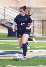 KHS JUNIOR Jennings Broddle pushes the ball down the field during Tuesday’s home loss to OKC Storm. Broddle scored Kingfisher’s lone goal in the game. [Photo by Russell Stitt/www.stitt.smugmug.com]