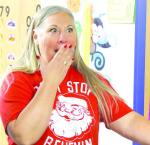 GILMOUR ELEMENTARY teacher Laurie Hagar reacts after being surprised with a grant award on Wednesday by members of the Kingfisher Educational Foundation (and Santa and Mrs. Claus). [KT&amp;FP Staff Photo]