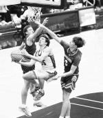 OKARCHE SENIOR guard Colin Hendrickson makes an acrobatic move to split two defenders as he scored during the first half of the Warriors’ area title win. [KT&amp;FP Staff Photo]