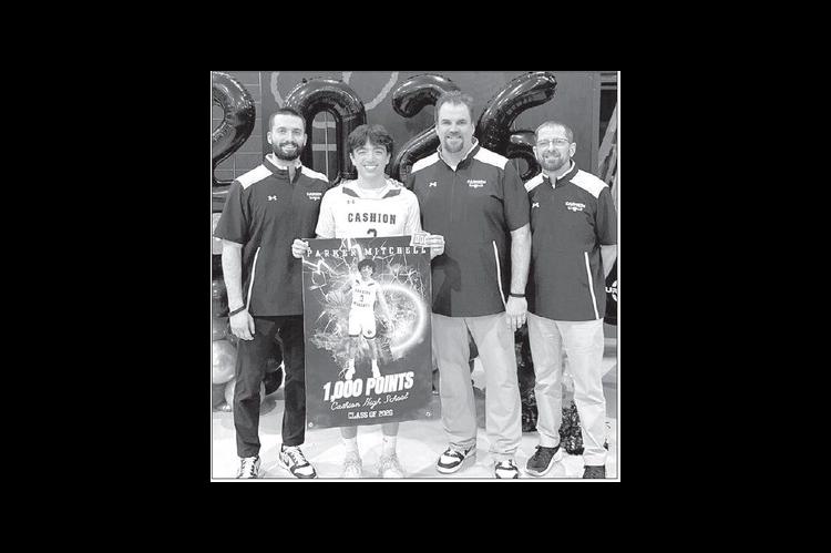 CASHION SENIOR guard Parker Mitchell was recognized prior to a game last week for surpasing 1,000 career points earlier this season. He’s pictured with Cashion coaches, from left, Brady Johnson, John Hardaway and Chad Tichenor. [Photo provided]