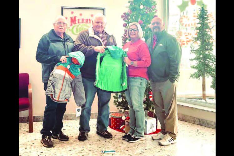 The Knights of Columbus recently made a warm donation to Santa’s Toyland. The group donated nearly 100 winter coats of various sizes to be distributed to local youth. Making the donation to Brittney Hladik (third from left), who represented Santa’s To