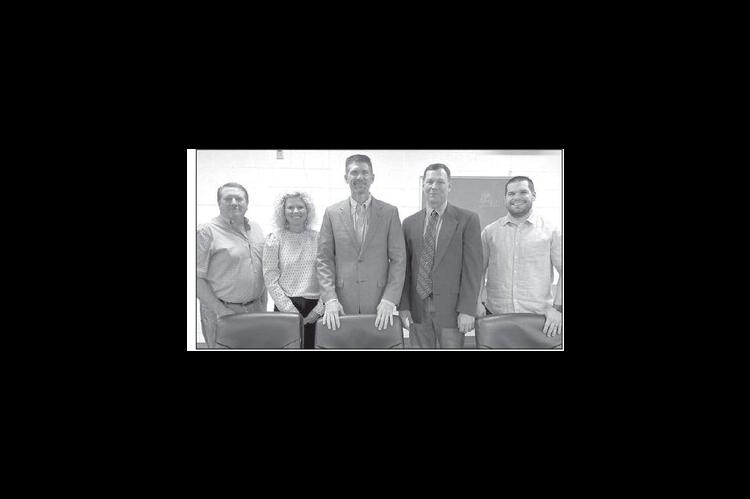 HENNESSEY BOARD OF EDUCATION members elected new officers, and welcomed a new member, during their Monday meeting. Pictured are, from left: Luke Lough, Amy Charmasson (clerk), Dr. James M. Matousek (president), Lance Painter (new board member) and Dakota 