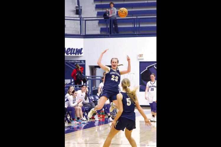 STATE BOUND – Kingfisher High School senior Raegan Snider (23) begins to celebrate with teammate Adlee Friesen (5) after the final seconds ticked off the clock of their team’s win over Oologah last Saturday. The victory advanced Kingfisher to the Clas
