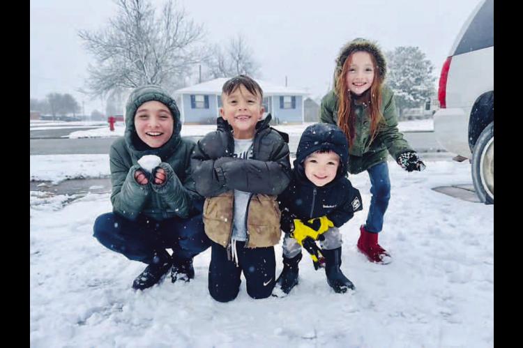 SNOW FUN – Vivienne Roy, 12, Wyatt Roy, 6, Holden Roy, 3, and Elizabeth Roy, 10, made the most of Thursday’s snowfall in Kingfisher. Their mother, Janie Roy, submitted the photo to the Kingfisher Times &amp; Free Press Facebook page. Snow continued ov