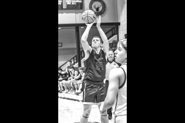 JHETT BIRDWELL is pictured shooting a 3-pointer during a game at Elk City. The junior made three treys in Saturday’s game at Clinton, including the eventual game winner. [Photo by Chris Simon/www.simon-sports-photos.smugmug.com]