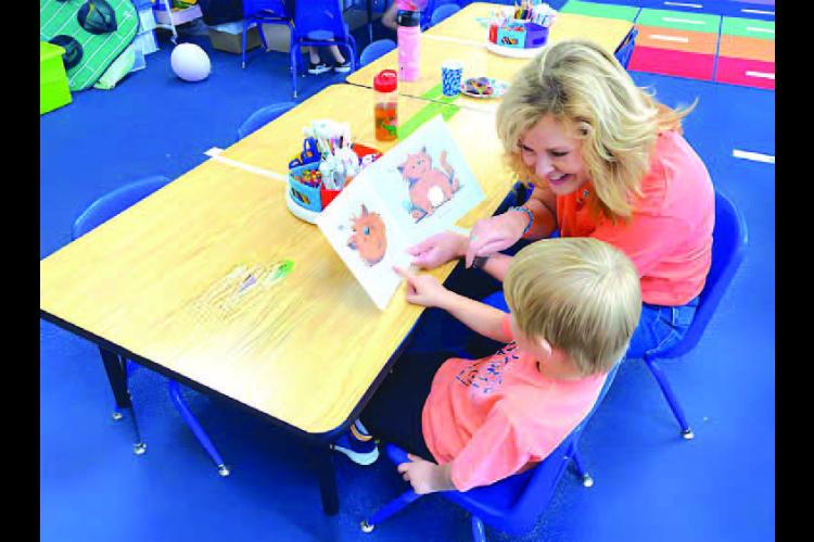 SWARM MENTOR - Tanya Cameron works with a student as a SWARM mentor. Cameron, a former Kingfisher Educational Foundation board member, helped form the mentoring program which now enters its third year. [Photo provided]