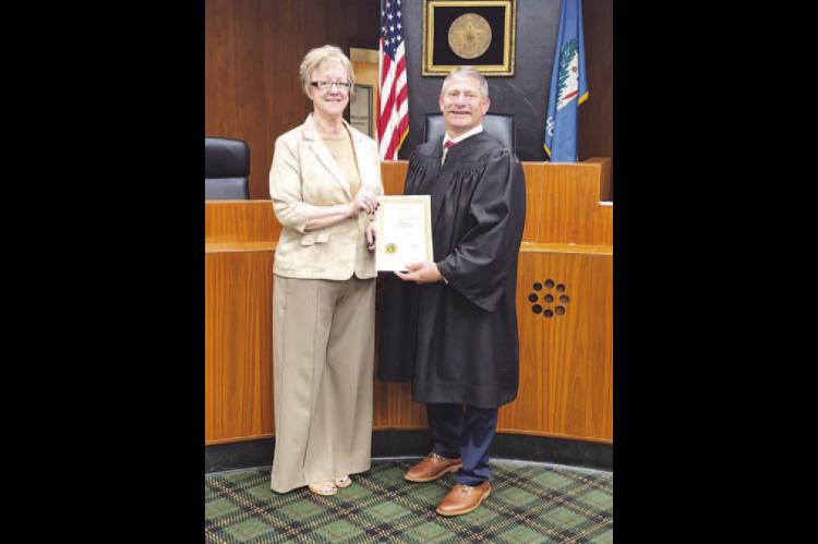 Kelly Majetic is officially the Kingfisher County treasurer. Majetic, left, was sworn into office Wednesday morning by Associate District Judge Lance Schneiter at the Kingfisher County Courthouse. She was appointed to fulfill the term of Robin Rother, whose retirement was effective at the end of business on Tuesday. Majetic will serve the final year of Rother’s term and then will begin her own four-year term in the office beginning next July. [Photo provided]