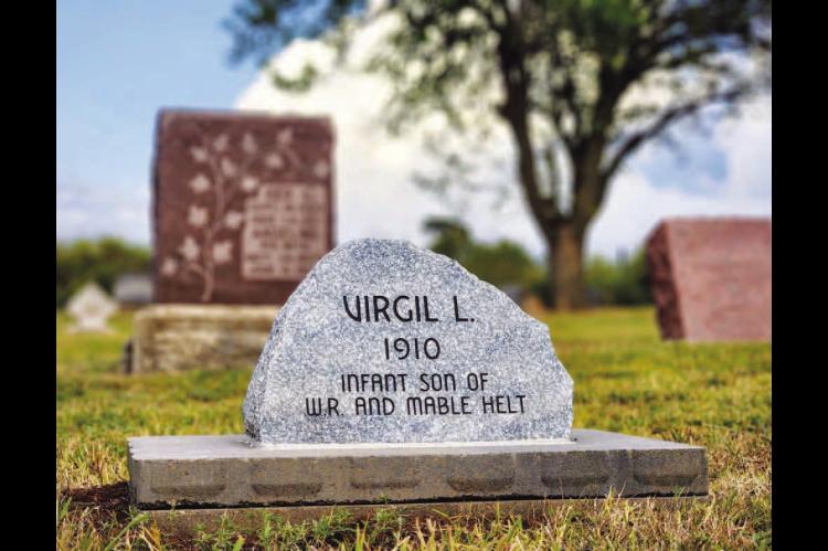 HERE LIES....Pictured is the newly-placed headstone for Virgil L. Helt at Grimes Cemetery east of Kingfi sher. Virgil lived for only four hours and his grave was unmarked for more than 100 years. His niece, Evelyn Helt-George, spent more than 30 years fi nding out more information about him, fi nding his burial plot and recently had a service to honor him. [KT&FP Photo by Twila Adams]