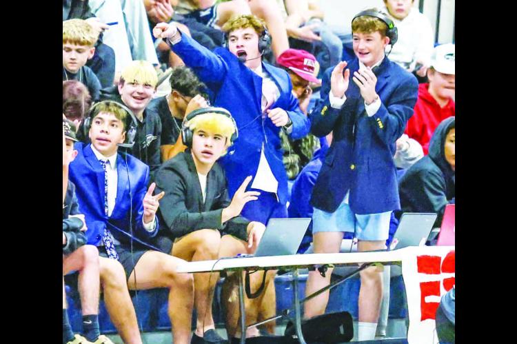 THE NEXT GENERATION? Members of the Kingfisher High School student section had their own makeshift broadcast table as part of their theme during last Tuesday’s home basketball games against Alva. The “broadcast crew” consisted of, from left, Luciano