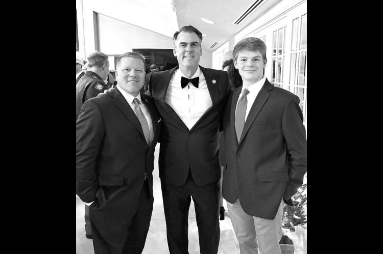 Kingfisher’s Mike and Davis Sanders attended the Christmas party of Governor Kevin Stitt (pictured center) and First Lady Sarah Stitt last Saturday at the Governor’s Mansion and Pavilion. Mike Sanders, left, is the executive director of the Oklahoma B