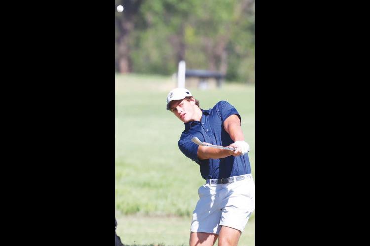 CALE REAGAN watches a chip shot during a golf tournament earlier this year. Reagan helped lead KHS to the state golf tournament and won an all-star tournament after the season. He’s pictured on the right side of the page during his junior year of football. A dominant defensive lineman for the Jackets, he was named the 3A-1 Defensive Player of the Year as a senior. [Golf photo by KT&FP Staff/Football photo by Chris Simon