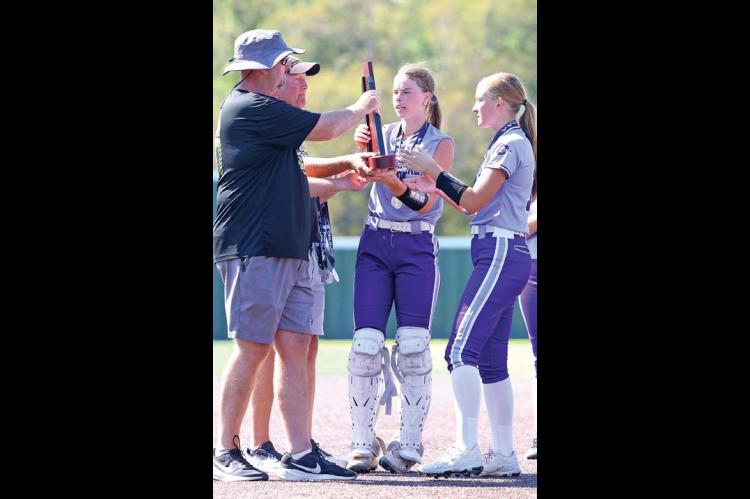 OKARCHE SUPERINTENDENT Josh Sumrall and OHS Principal G.W. Parham present the Class A softball state runner-up trophy to Callie Cramer and Katie Parham (far right) after last Saturday’s championship game in Shawnee. [KT&FP Staff Photo]