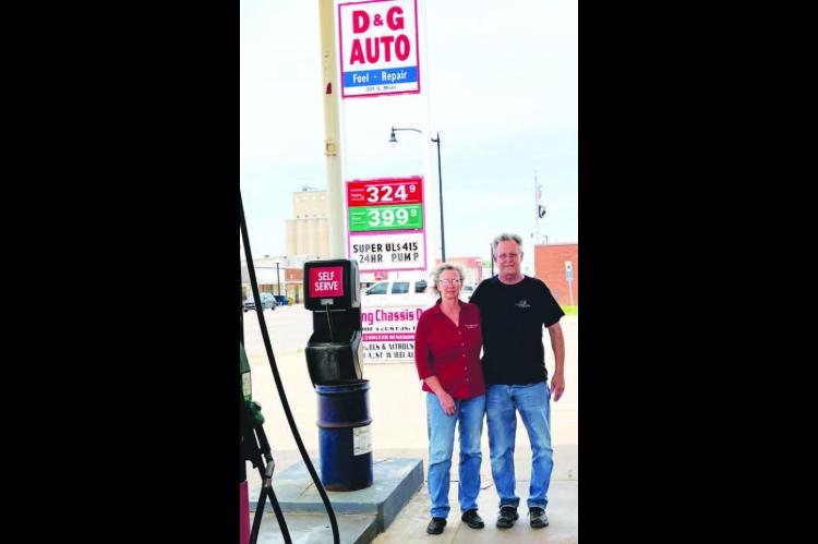 READY TO RETIRE – Grace and Dewayne Ebers stand outside their service station, D&amp;G Auto, in Hennessey. The longtime owners and operators are “semi-retiring” at the end of the week as they prepare to meet their new grandchild in Texas. [Photo by Barb Walter]