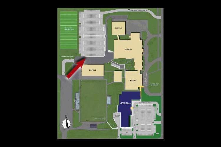 WORK TO BEGIN soon on a new parking lot on the Kingfi sher High School campus (indicated by red arrow, above) to replace existing parking that will be lost in the construction of the 7th &amp; 8th Grade Center.