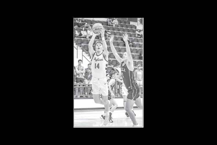HAYES WHITE leans in for a jumper during Kingfisher’s loss to Inola in Thursday’s Class 4A area tournament action. [Photo by Chris Simon/www.simon-sports-photos.smugmug. com]