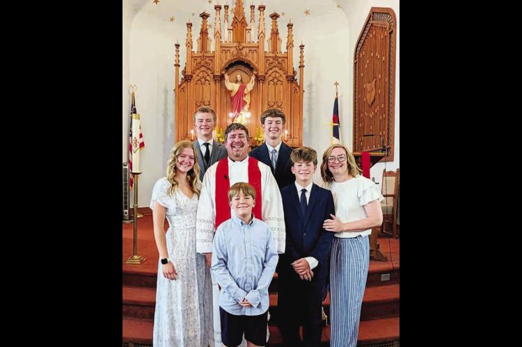 STARK FAMILY – Clint Stark is the new pastor at St. John’s Lutheran Church in Okarche. The Stark family has recently moved to Okarche from Texas. Pictured with Clint and his wife Brianne (far right) at the church are their son Benjamin (front row), daughter Mary (far left) and sons Simeon (middle row), Henry and Wyatt (back row). [Photo provided]