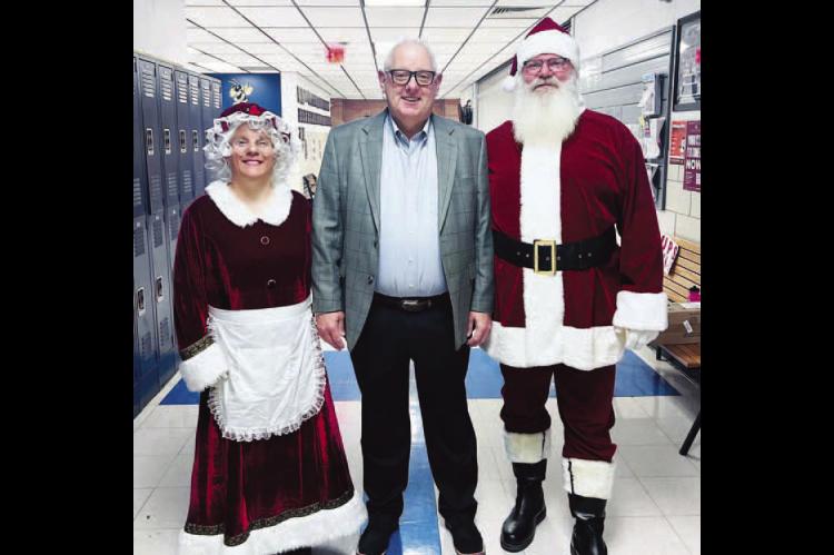 SANTA AND MRS. CLAUS are pictured with KPS Interim Superintendent Andy Evans. The Clauses were making their way through the various buildings last week to help distribute awards from the Kingfisher Educational Foundation. [Photo provided]