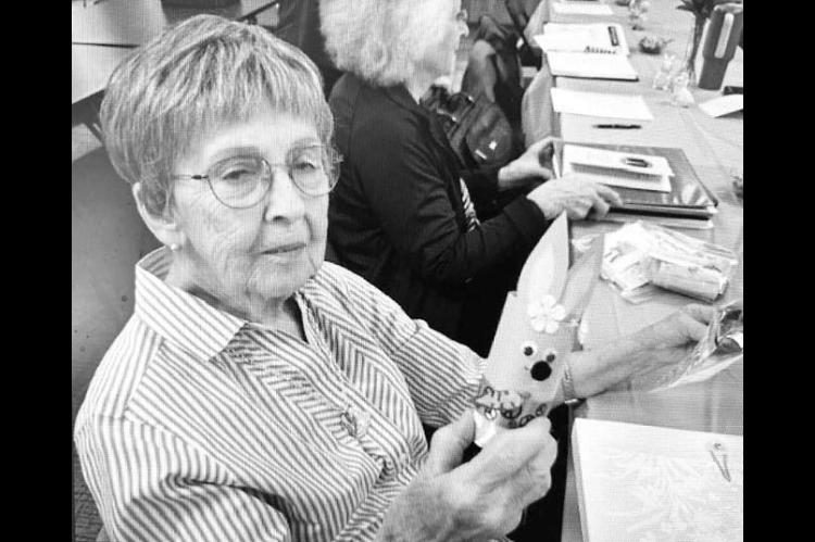 HENNESSEY FARMERETTE member Kathy Patocka holding one of the Easter craft projects the group made for the library during its March meeting. [Photo provided]