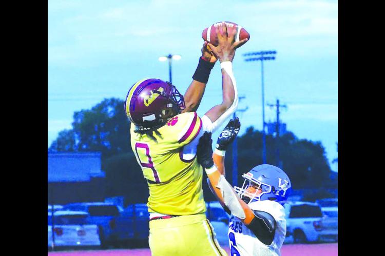 CASHION WIDEOUT King Underwood flies high for a touchdown grab on the final play of the first half in his team’s win against Hennessey. [KT&amp;FP Staff Photo]