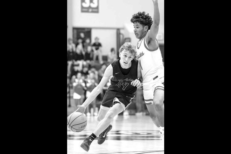 SENIOR GUARD Croston Martin (24) drives against Dale during last Friday’s semifinal game. Martin and the Jackets won two of three games in the tournament for third place. [Photo by Russell Stitt/www.stitt.smugmug.com]