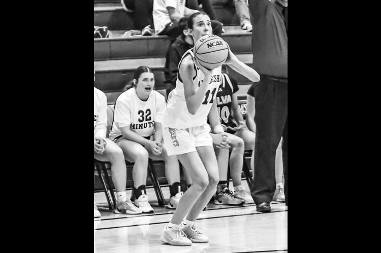 ELA HARTMAN eyes a 3-pointer in the first half against Alva. Her offense and defense played big roles in Kingfisher’s 15-point victory. [Photo by Chris Simon/www.simon-sports-photos. smugmug.com]
