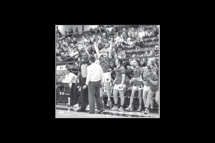 CASHION GIRLS coach Andrea Taylor speaks with an official as team members celebrate a big play during a home win over Seiling on Tuesday. [Photo by Rylee Broadbent]