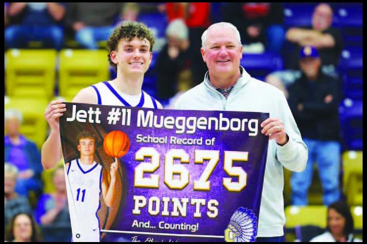 OKARCHE SENIOR guard Jett Mueggenborg gets set to release the shot that gave him the school’s all-time scoring record. Mueggenborg’s was tied with Barry Schwarz at 2,674 points when he nailed the shot pictured left. He went on to score 34 points in the game Tuesday. Afterward, Schwarz, who graduated in 1991 with the old scoring mark, presented Mueggenborg with a banner commemorating his accomplishment during a brief ceremony. [KT&amp;FP Staff Photos]