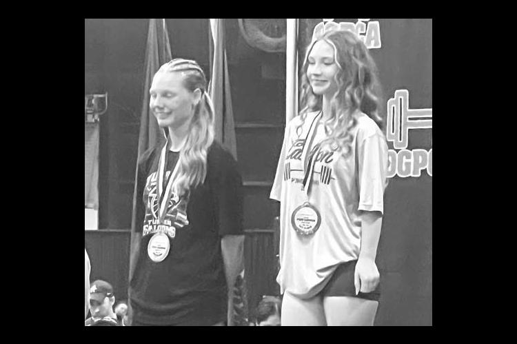 MAKAYLA HINES (right) stands atop the podium after winning the OGPCA 105-pound title. [Photo provided]