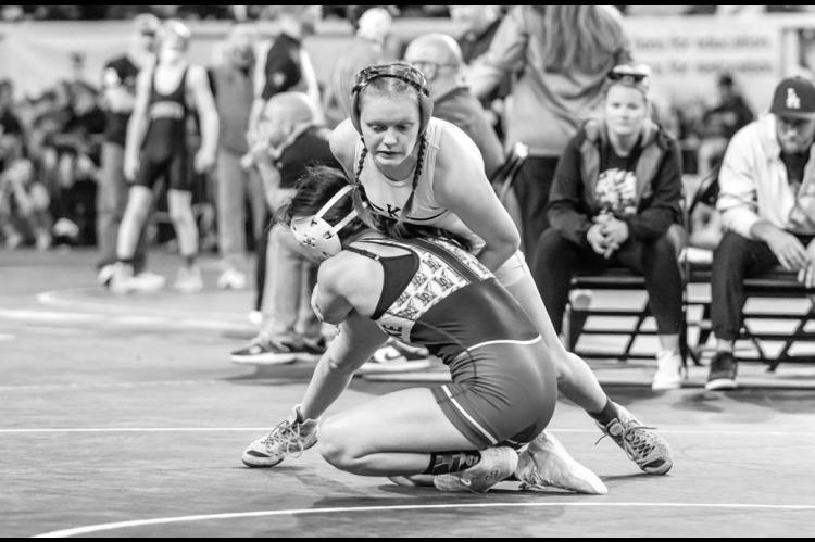 RYLEE HAMIL fights off a takedown attempt by Little Axe’s Sydney Harris during the 115-pound wrestle-in match Thursday at the Class 5A girls state tournament. Hamil became the first female from KHS to qualify for and wrestle in the state tournament. [Ph