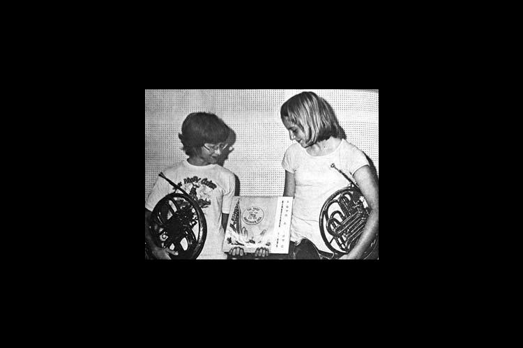 ALL FOUR KINGFISHER school bands, the high school band, the 7th and 8th grade band, the sixth grade band and the fifth grade band, may be heard on a new record just released, and two who helped make the record are looking it over. Both of them play the French Horn, and shown here are left, Leigh Ann Chlouber and right, Lori Snow. (Times, June 17, 1976)