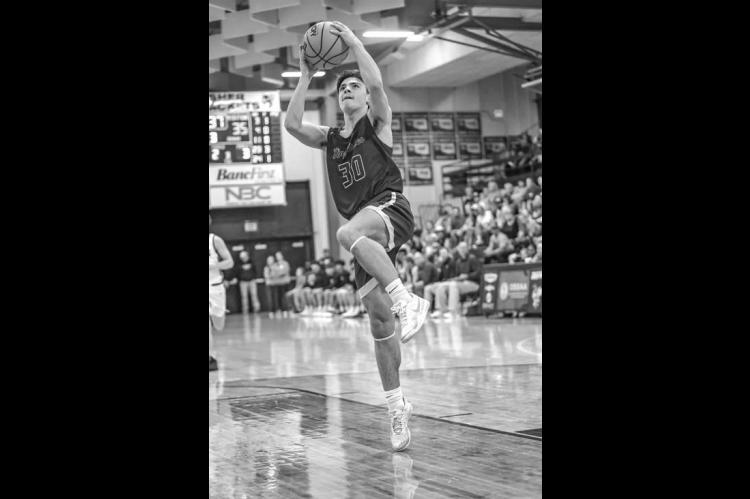 KHS FRESHMAN Daxx Compton goes up for a layup during the second half of Kingfisher’s regional final loss to Weatherford. [Photo by Chris Simon/www.simon-sports-photos. smugmug.com]