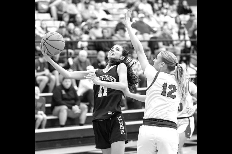 KINGFISHER’S Ela Hartman (left) goes up for a shot against Washington’s Eternity Self (12) during the championship game. Hartman scored a game-high 17 points. Pictured right is Reese Roof shooting a 3-pointer as Washington coach Kale Simon looks on. [