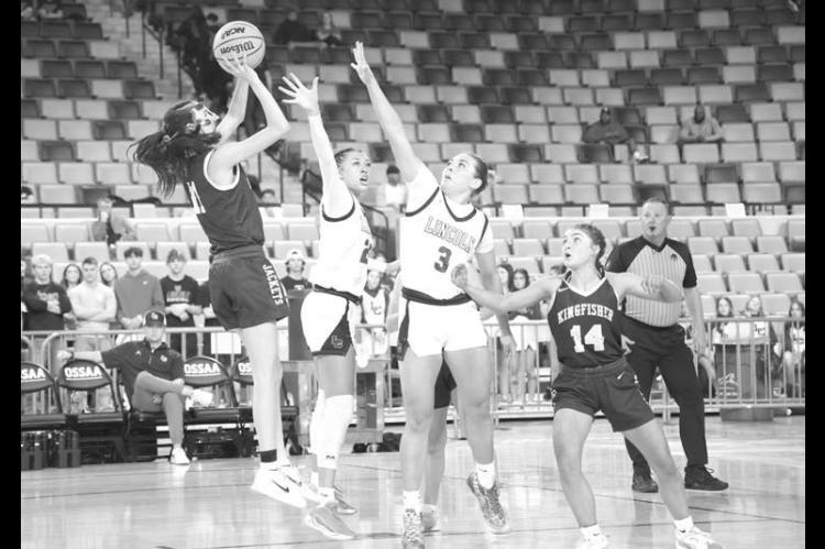 KHS SOPHOMORE Ela Hartman shoots over a pair of Lincoln Christian defenders during the first half of Tuesday’s contest in Oklahoma City. [KT&amp;FP Staff Photo]