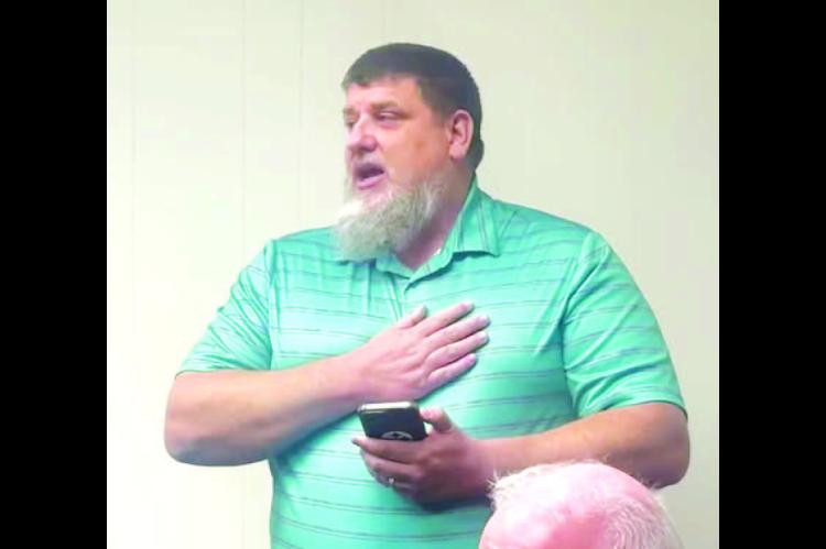 STUART PURINTUN addresses the members of the Kingfisher Board of Education prior to a vote that would see 18 people lose their jobs due to a reduction in force on Wednesday. [KT&amp;FP Staff Photo]