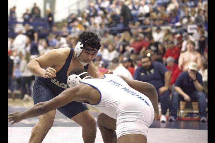 KHS SENIOR Jose Santoyo wrestles Mount St. Mary’s Donald Sanders during the quarterfinals of the 215-pound weight class of the Class 3A regional last Friday. Santoyo lost this match, but went on to win five of his next six to qualify for state for the f
